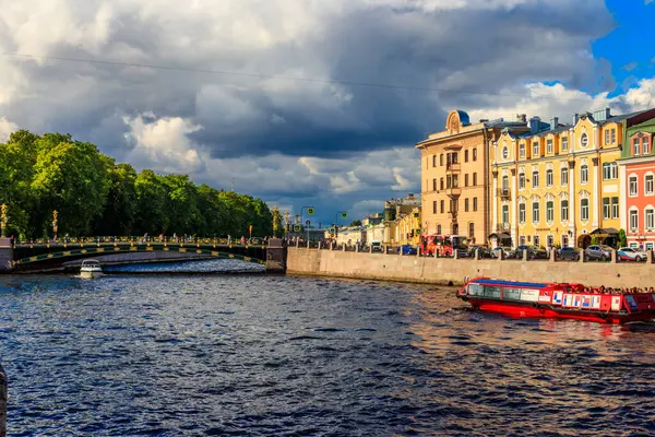 St. Petersburg, Russia - June 26, 2019: Tourist boats sailing on the Fontanka river near Panteleymonovsky Bridge in Saint Petersburg, Russia