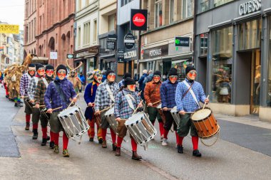 Basel, İsviçre - 28 Şubat 2023: İsviçre 'nin Basel kentinde düzenlenen geleneksel karnaval geçidi sırasında kostümlü karnaval katılımcıları