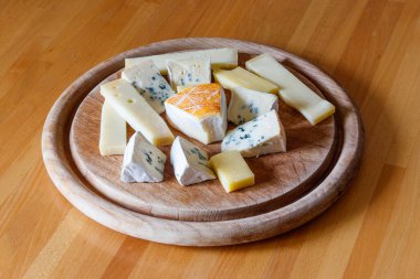 Tahta masada farklı peynirler bulunan peynir tabağı.