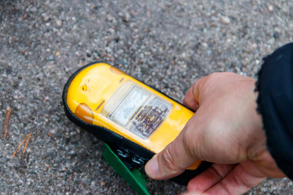 Male hand holding a dosimeter. Measurement of radiation levels by the Geiger counter in Chernobyl Exclusion Zone, Ukraine