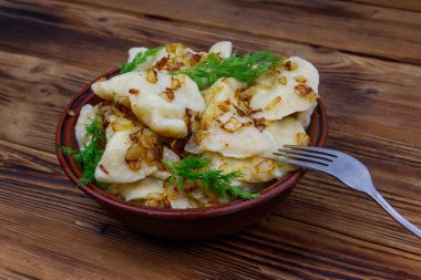 Delicious homemade dumplings on a wooden table