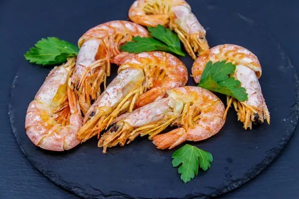 Boiled large langoustines on a black slate