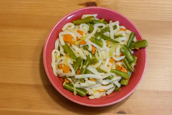 stock image Udon noodles with vegetables on wooden table. Japanese cuisine. Asian food