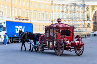 St. Petersburg, Russia - June 24, 2019: Horse-drawn carriage riding on the Palace Square in Saint Petersburg, Russia clipart