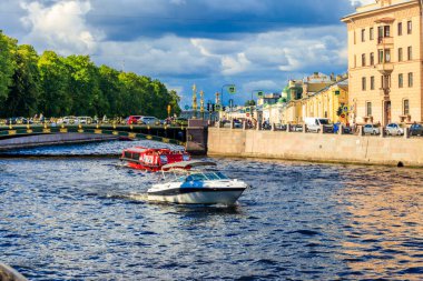 St. Petersburg, Russia - June 26, 2019: Tourist boats sailing on the Fontanka river near Panteleymonovsky Bridge in Saint Petersburg, Russia