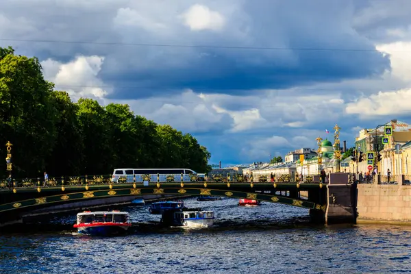 St. Petersburg, Russia - June 26, 2019: Tourist boats sailing on the Fontanka river near Panteleymonovsky Bridge in Saint Petersburg, Russia