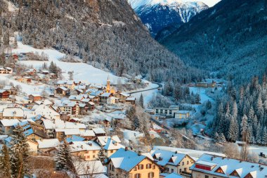 Winter view of small town Filisur in Switzerland at evening clipart