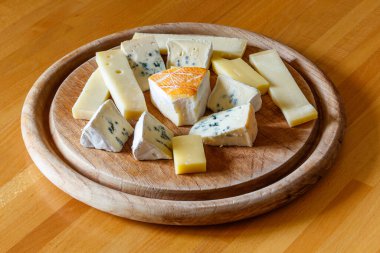 Tahta masada farklı peynirler bulunan peynir tabağı.