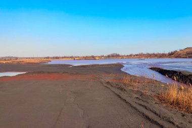 Technical settler of industrial water of mining industry in Kryvyi Rih, Ukraine. Red water polluted with iron ore waste clipart