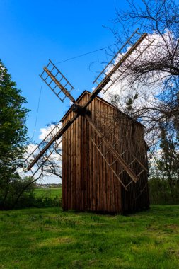 Old wooden windmill in Open-air Museum of Folk Architecture and Folkways of Middle Naddnipryanschina in Pereyaslav, Ukraine clipart