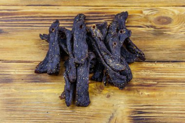 Slices of biltong (South African dried meat) on wooden table