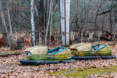 Abandoned bumper cars in the amusement park of Pripyat city in Chernobyl Exclusion Zone, Ukraine clipart