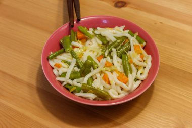 Udon noodles with vegetables on wooden table. Japanese cuisine. Asian food clipart