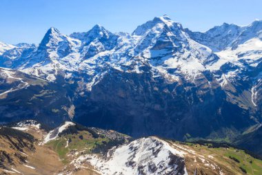 View of three famous Swiss mountain peaks Eiger, Monch and Jungfrau in the Bernese Oberland in Switzerland