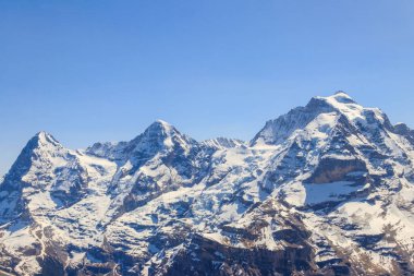 View of three famous Swiss mountain peaks Eiger, Monch and Jungfrau in the Bernese Oberland in Switzerland
