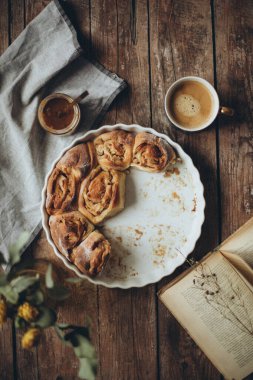 homemade apple pie with cinnamon and nuts on a wooden background