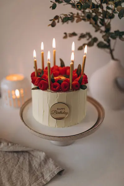 birthday cake with roses and candle on a white background.