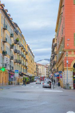 Nice, France, 13.02.2024: Architecture of the old town in Nice. A little Italian style with French motifs. Colorful houses and narrow streets. clipart