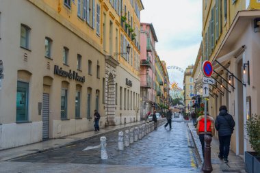 Nice, France, 13.02.2024: Architecture of the old town in Nice. A little Italian style with French motifs. Colorful houses and narrow streets. clipart