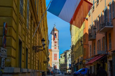 France, Nice, 11.02.2024: French flag against the background of the old city of Nice and the cathedral clipart