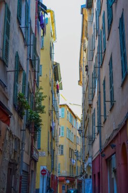 Nice, France, 13.02.2024: Architecture of the old town in Nice. A little Italian style with French motifs. Colorful houses and narrow streets. clipart