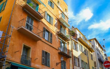 Nice, France, 13.02.2024: Architecture of the old town in Nice. A little Italian style with French motifs. Colorful houses and narrow streets. clipart