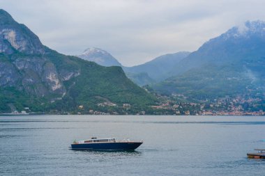 Italy, Bellagio, 22.03.2024: Bellagio promenade overlooking the mountains at sunrise and Lake Como clipart