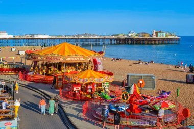 UK, Brighton, 18.07.2023: View to promenade with restaurants and carousels clipart