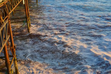 Small storm at sunset, high waves with white foam clipart