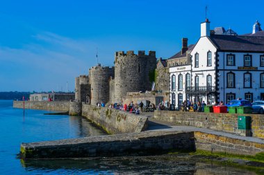 Caernarfon castle towers in bright sunlight clipart