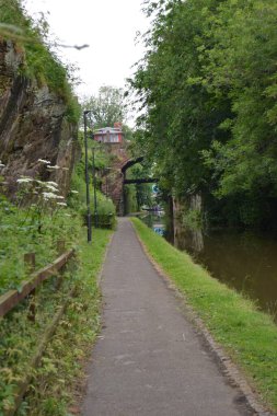 The main river canal in the town of Chester, which is used by barges and docks. Canal along the old city wall. clipart