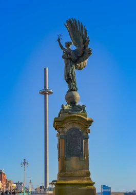 UK, Brighton, 11.1.2025: Angel of Peace statue with I360 in the background clipart