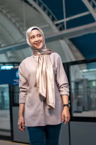 Asian muslim woman on subway train transit system public. Public transport concept