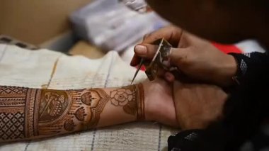 henna tattoo on hands Bridal mehendi. Indian marriage. Henna tattoo applying.