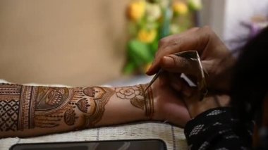 henna tattoo on hands. Bridal mehendi. Indian marriage. Henna tattoo applying.