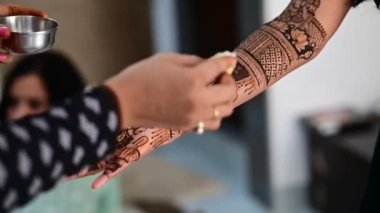 Apply lemon juice and oil on henna tattoo on hands close up. Bridal mehendi in process. Indian marriage elements. Henna tattoo applying.