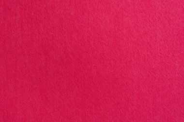 Doğal kırmızı ya da pembe kumaşın yakın çekim dokusu. Kumaş arka plan olarak. Tasarım için parlak malzeme.