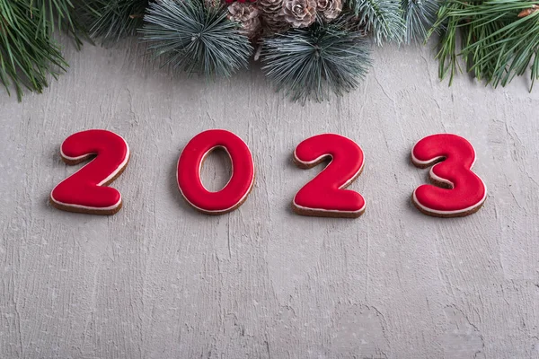 ジンジャーブレッドとクリスマスリースからの赤い番号2023 良い新年の精神 背景に薄灰色の壁 — ストック写真