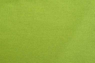 Arka plan olarak doğal açık yeşil pamuk ya da keten kumaş dokusu. Tekstil kumaşı.