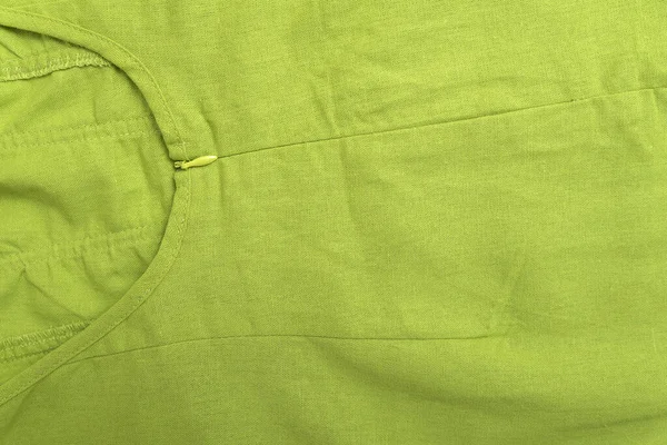 Cotton or linen tissue as background. Part of summer clothes with zipper light green color.