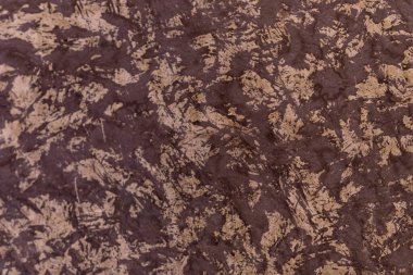 Abstract ruffled brown background. Decorative plaster. Rough surface