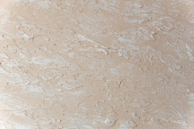 Duvarda dekoratif bej macun örneği var. Dekoratif alçı beton desenli arka plan. Desenli.