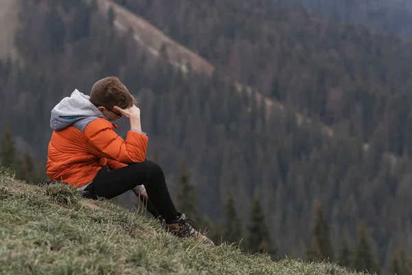 Genç Adam Yamaçta Oturur Bir Şeyler Düşünür Doğada Hafta Sonu — Stok fotoğraf