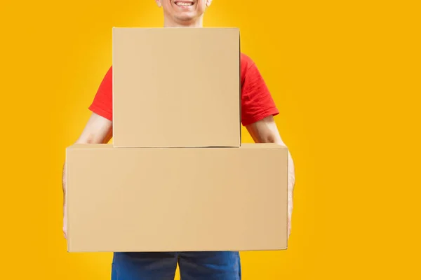 Man Holding Large Cardboard Boxes Bright Yellow Background Courier Postman Royalty Free Stock Images