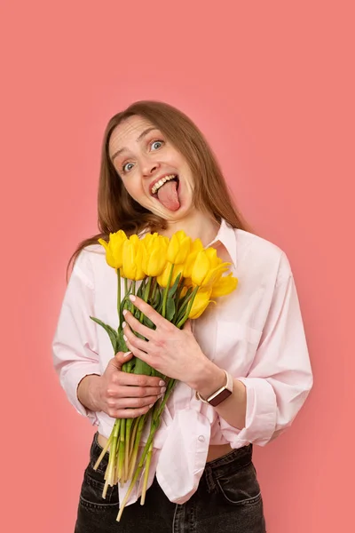 Funny Young Woman Holding Bouquet Yellow Flowers Showing Tongue Camera Stock Image