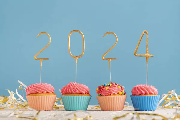 Holiday Muffins Pink Butter Cream 2024 Numbers Blue Background Happy Royalty Free Stock Images