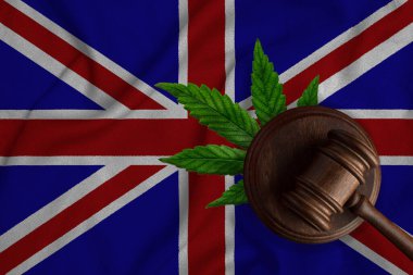 Büyük Britanya bayrağı ve kenevir yapraklı ahşap tokmak. Esrar bitkisinin ve uyuşturucuların yayılmasının yasadışı büyümesi