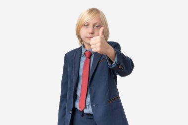 Başparmaklar yukarı. Takım elbiseli genç bir çocuğun portresi. Baş parmak işareti yapıyor.