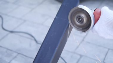 Man doing metal work using hand cutting machine tool