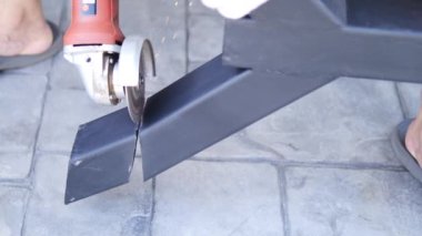 Man doing metal work using hand cutting machine tool